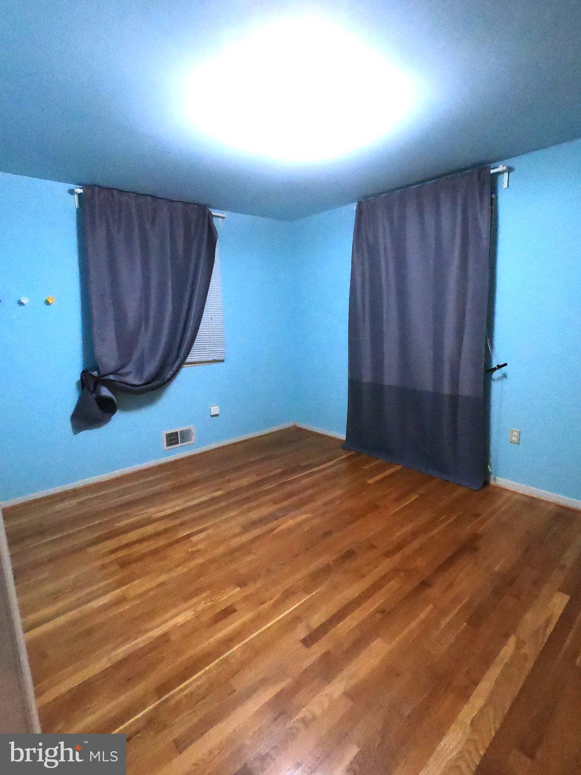 11806 Seven Locks Road Potomac, MD 20854 - Photo 6 of 8 Bright and airy room with blue walls.
