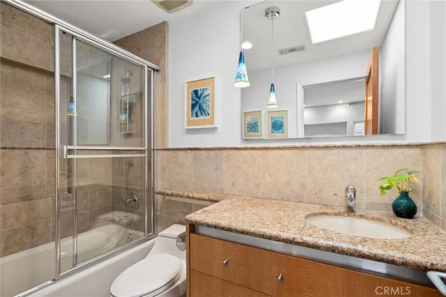 a bedroom with a bed couch and a window