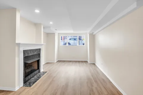 a view of a room wooden floor and a fireplace