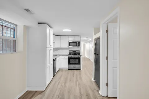 a kitchen with stainless steel appliances a refrigerator and a stove top oven