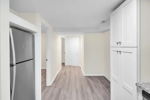 a view of hallway with wooden floor