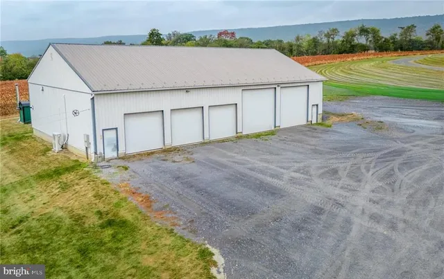 a aerial view of a house with a yard and garage