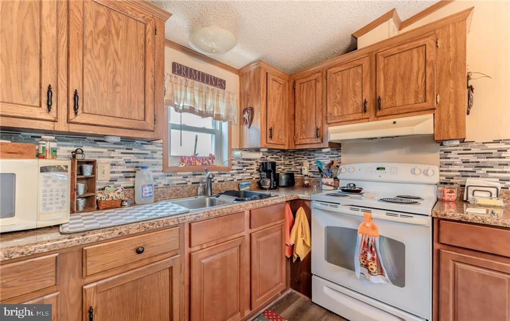 7573 Springhouse Road New Tripoli, PA 18066 - Photo 42 of 54 a kitchen with stainless steel appliances granite countertop a sink a stove and cabinets