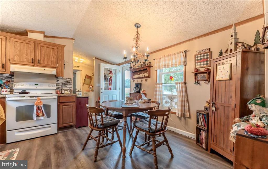 7573 Springhouse Road New Tripoli, PA 18066 - Photo 43 of 54 a kitchen with stainless steel appliances a dining table chairs stove and refrigerator