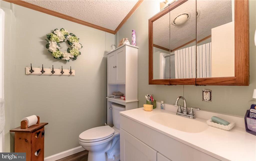 7573 Springhouse Road New Tripoli, PA 18066 - Photo 47 of 54 a bathroom with a sink mirror toilet and vanity