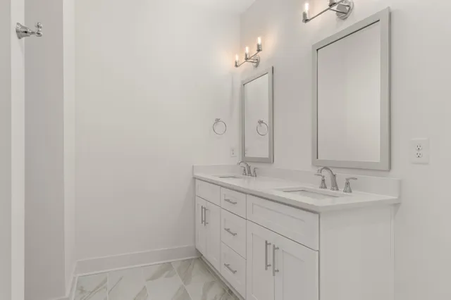 a bathroom with a double vanity sink and a mirror