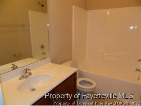 57 Ginseng Street Spring Lake, NC 28390 - Photo 18 of 25 a bathroom with a sink and a mirror