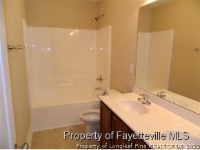 57 Ginseng Street Spring Lake, NC 28390 - Photo 21 of 25 a bathroom with a sink a toilet and shower