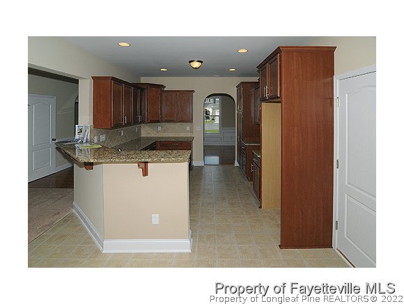 57 Ginseng Street Spring Lake, NC 28390 - Photo 3 of 25 a kitchen with stainless steel appliances granite countertop a refrigerator a sink and a stove