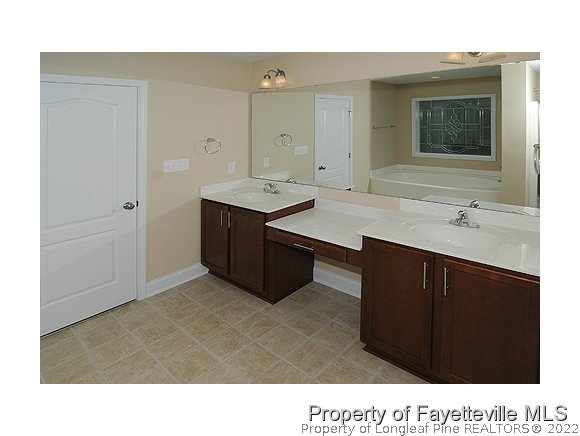 57 Ginseng Street Spring Lake, NC 28390 - Photo 8 of 25 a bathroom with a sink vanity and mirror