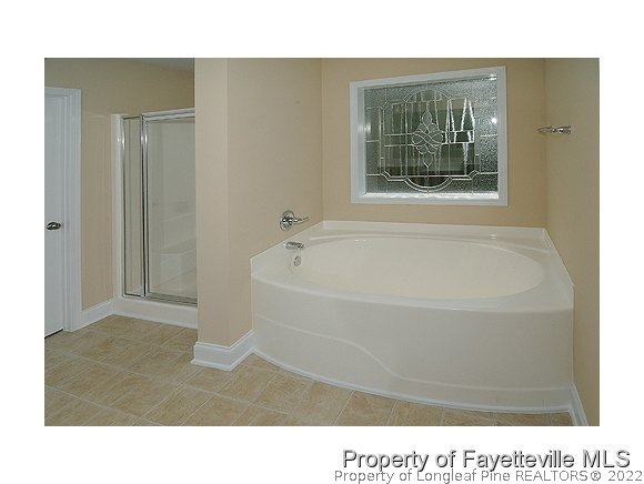 57 Ginseng Street Spring Lake, NC 28390 - Photo 9 of 25 a bathroom with a tub shower and sink
