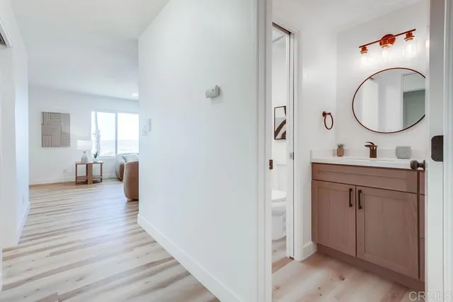 a bathroom with a sink a toilet and a mirror