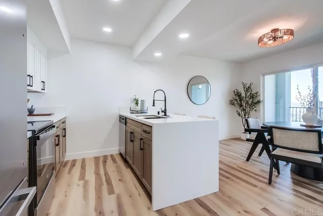 a kitchen with a sink appliances and cabinets