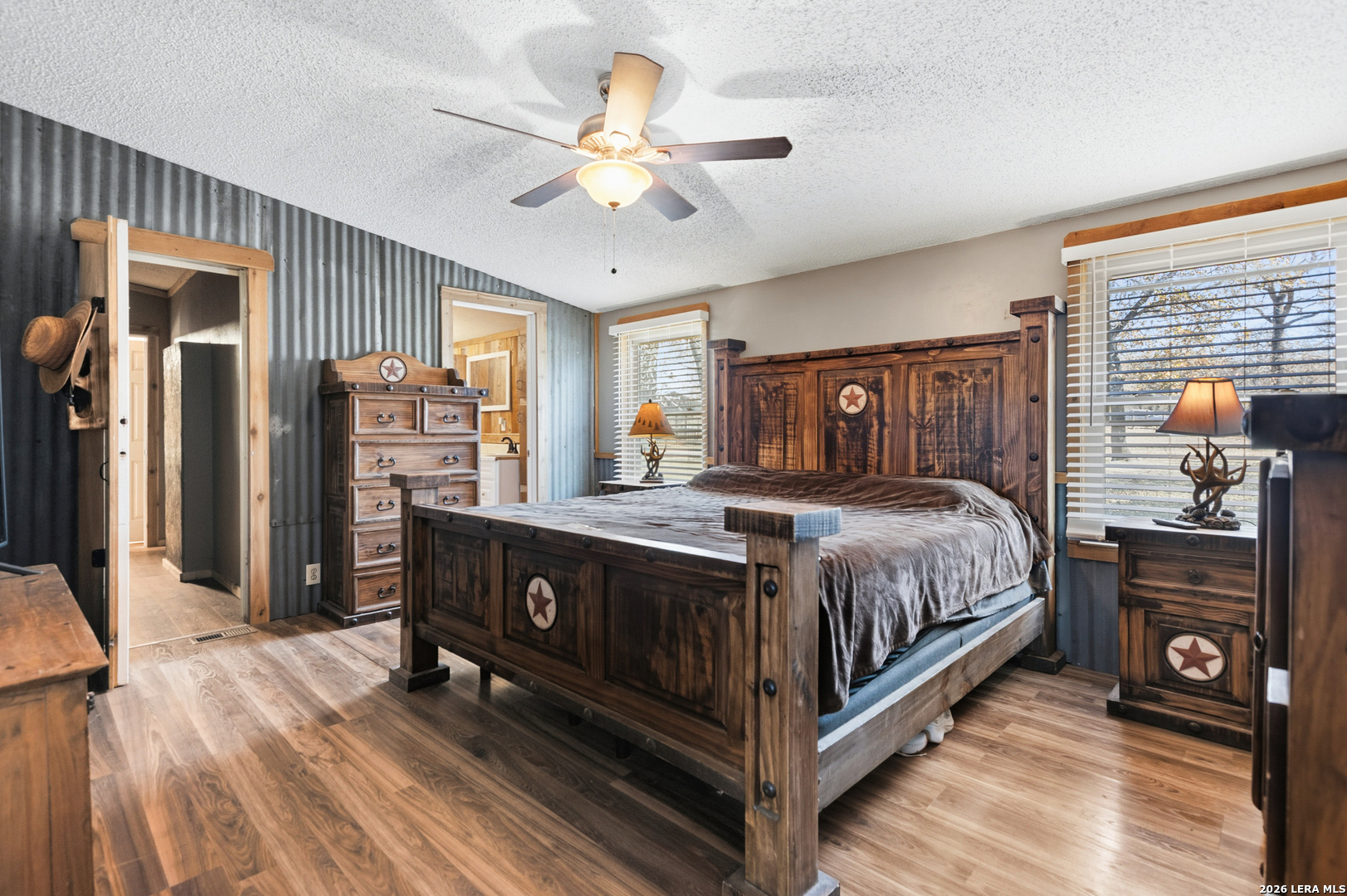 470 Lyon Road Seguin, TX 78155 - Photo 20 of 43 a bedroom with a bed and a flat tv screen on dresser