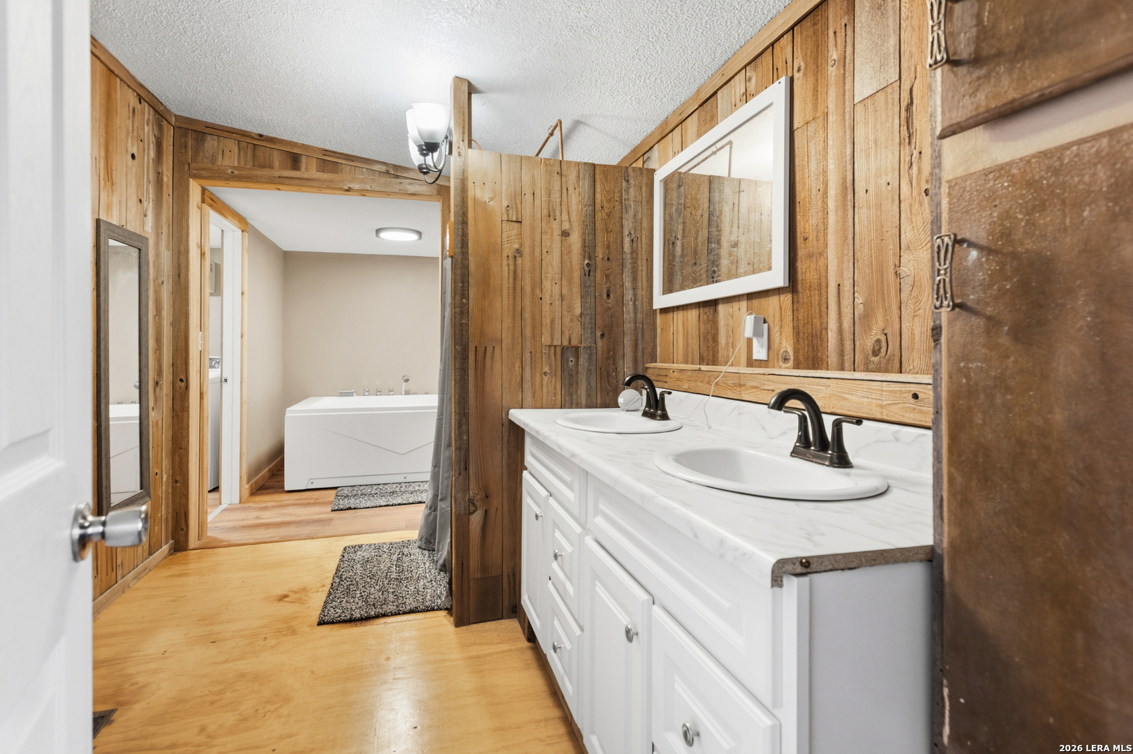 470 Lyon Road Seguin, TX 78155 - Photo 22 of 43 a spacious bathroom with a double vanity sink and a mirror