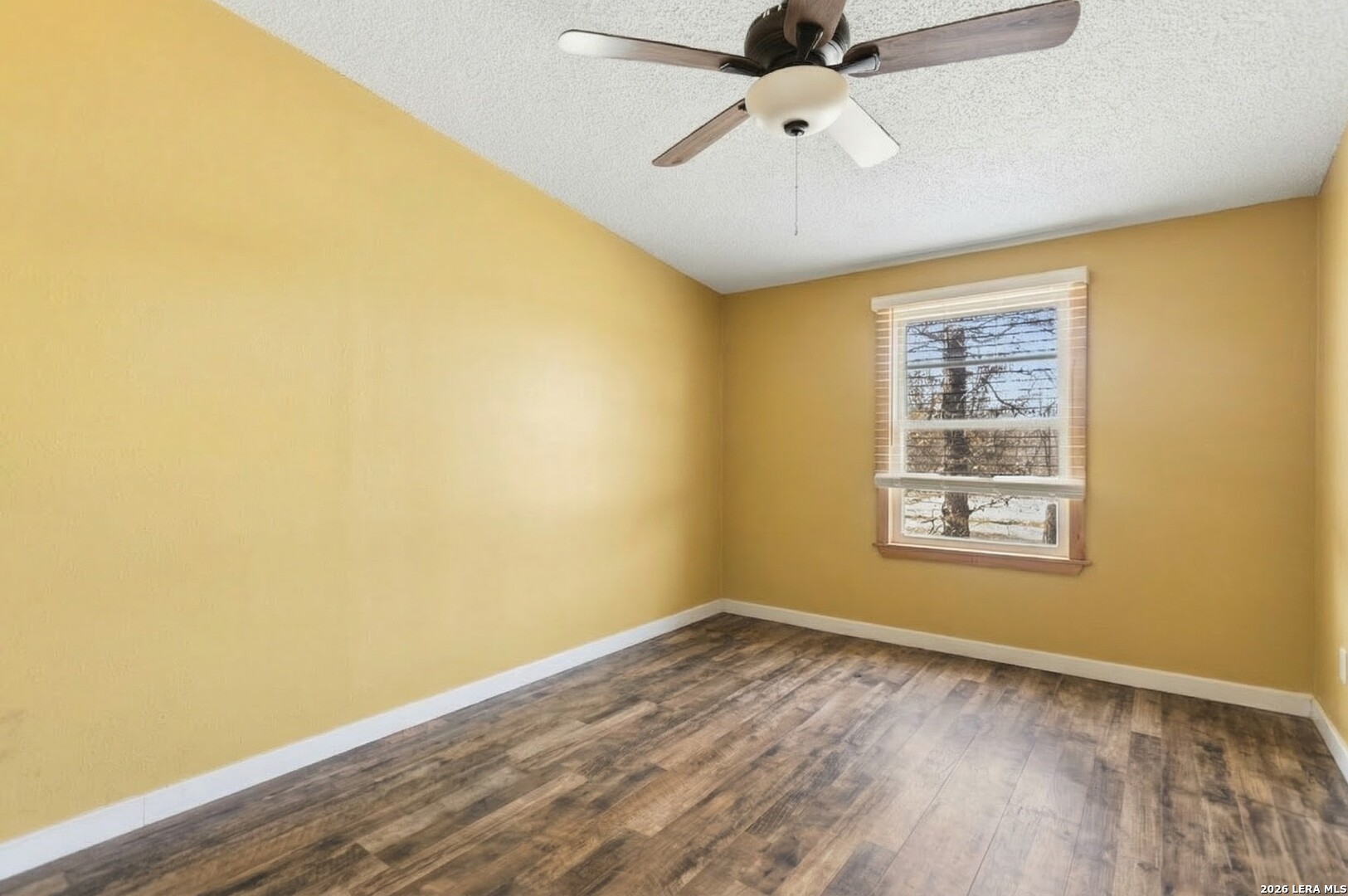 470 Lyon Road Seguin, TX 78155 - Photo 28 of 43 a view of an empty room with wooden floor and a window