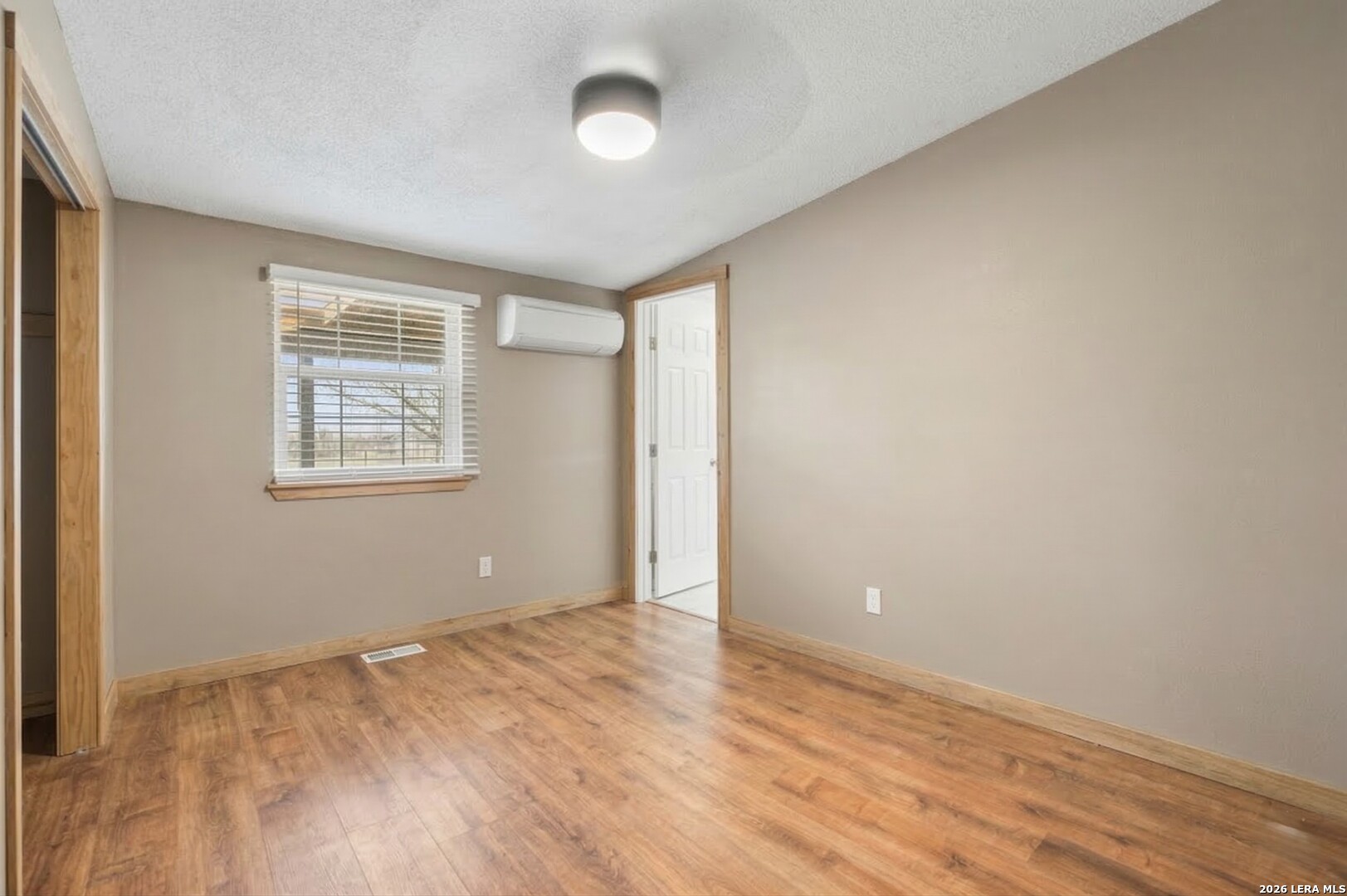 470 Lyon Road Seguin, TX 78155 - Photo 29 of 43 an empty room with wooden floor and windows