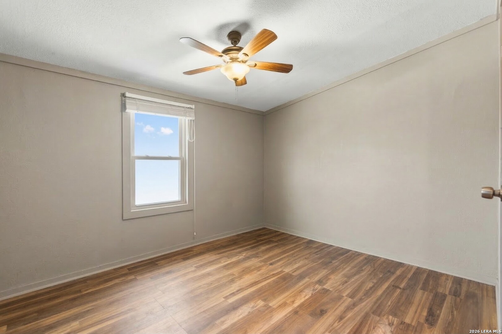 470 Lyon Road Seguin, TX 78155 - Photo 34 of 43 an empty room with window and ceiling fan