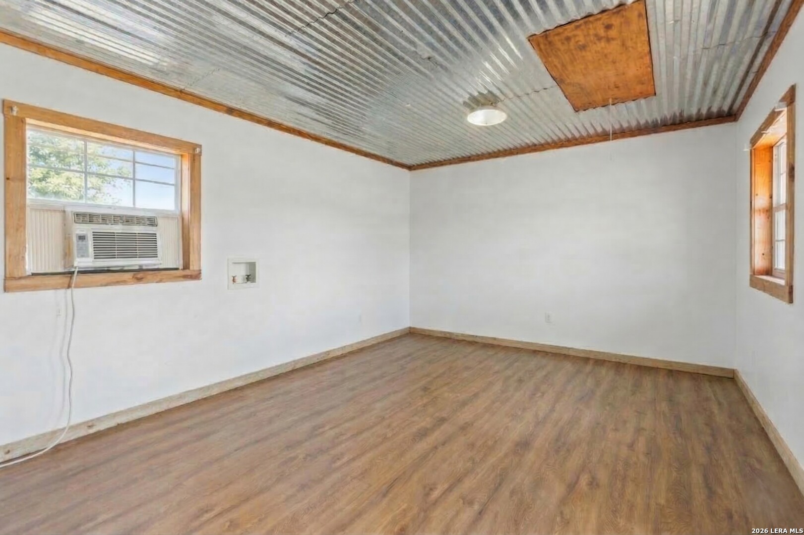 470 Lyon Road Seguin, TX 78155 - Photo 37 of 43 a view of an empty room with wooden floor and a window