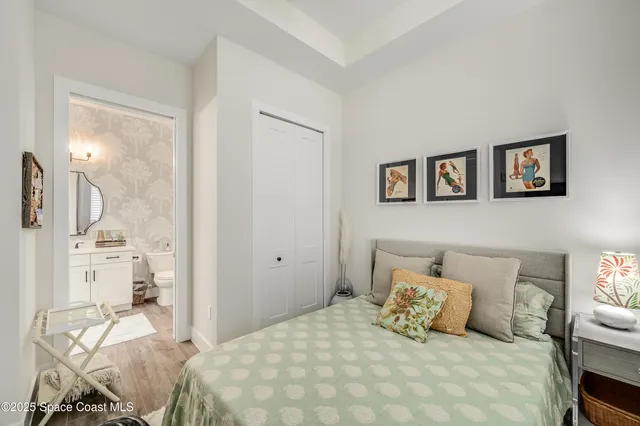 a bedroom with a bed a mirror and a window