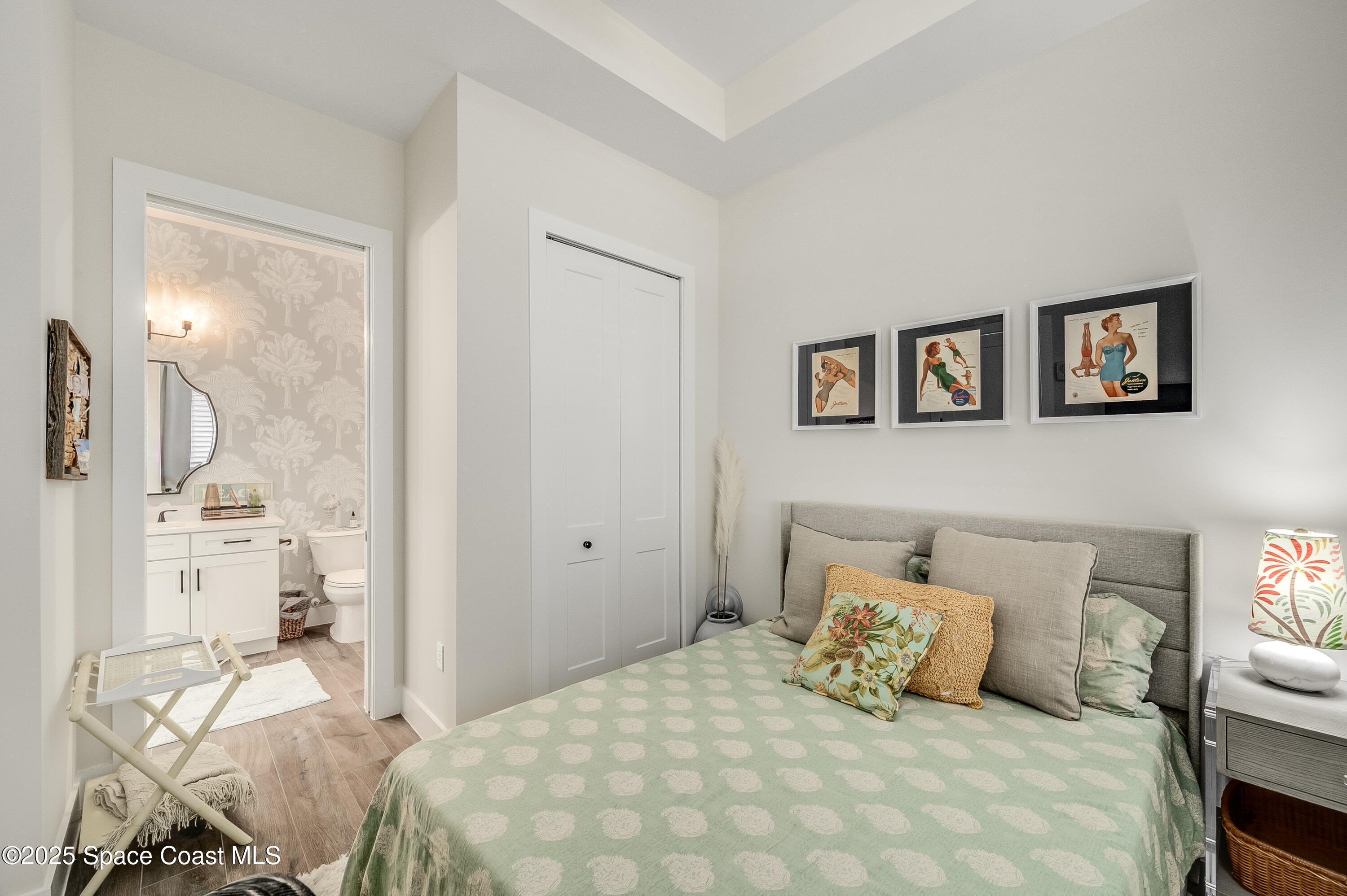 225 Strand Drive, Unit 404 Melbourne Beach, FL 32951 - Photo 11 of 51 a bedroom with a bed a mirror and a window