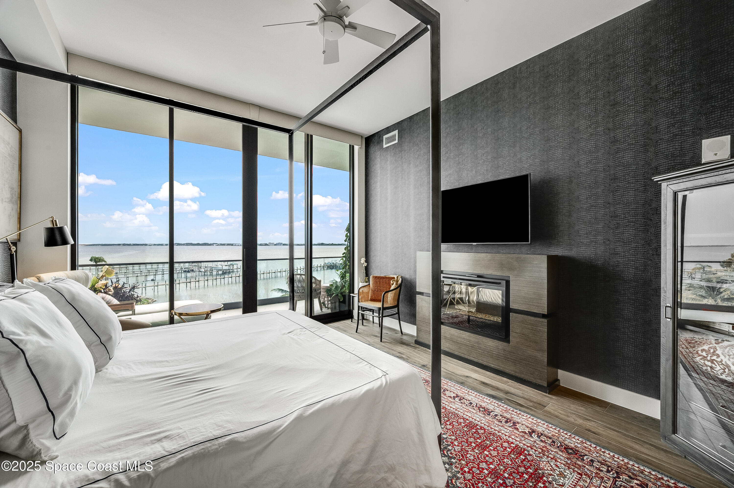 225 Strand Drive, Unit 404 Melbourne Beach, FL 32951 - Photo 17 of 51 a bedroom with a bed and a flat screen tv