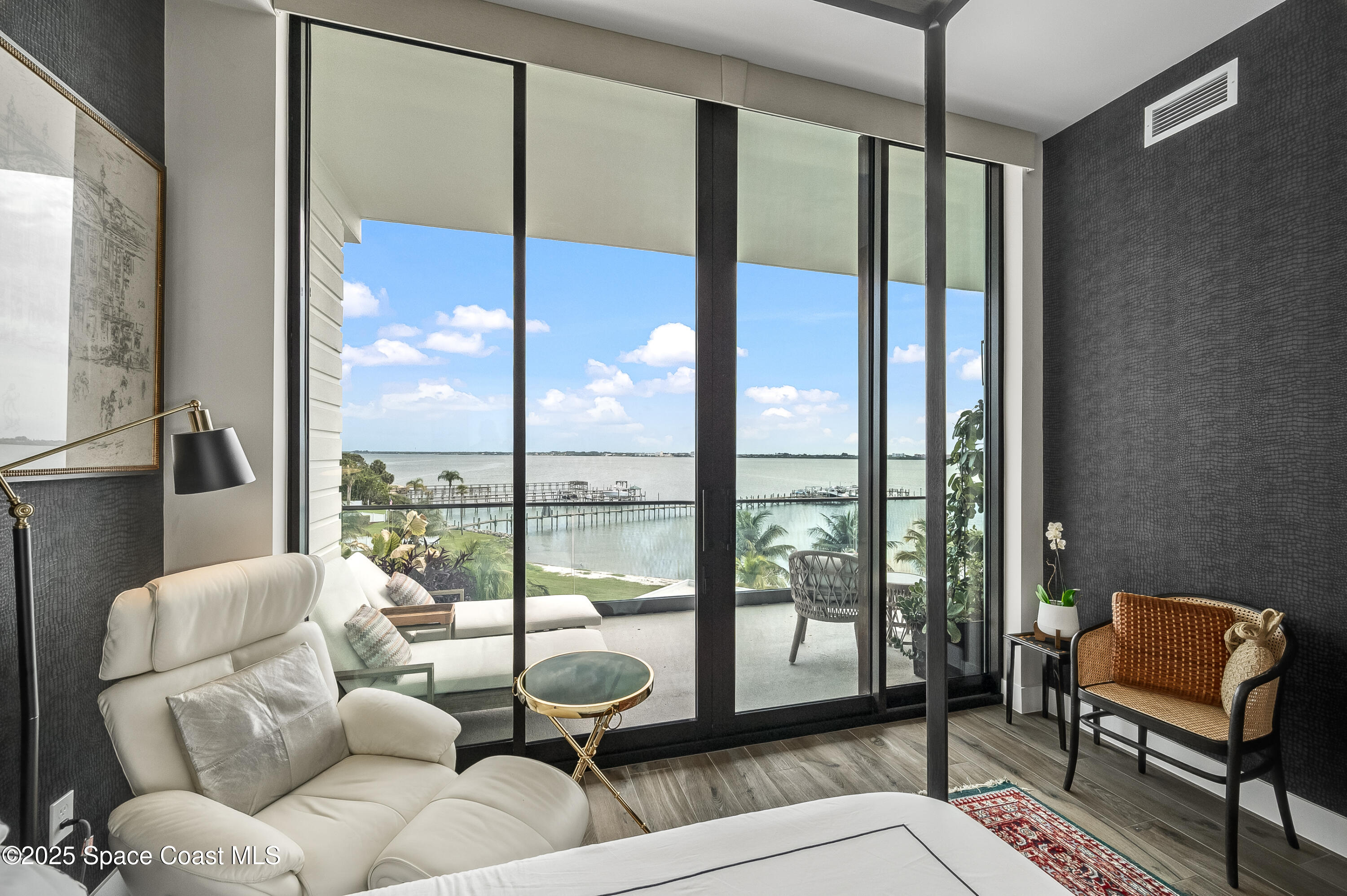 225 Strand Drive, Unit 404 Melbourne Beach, FL 32951 - Photo 19 of 51 a living room with furniture and a floor to ceiling window