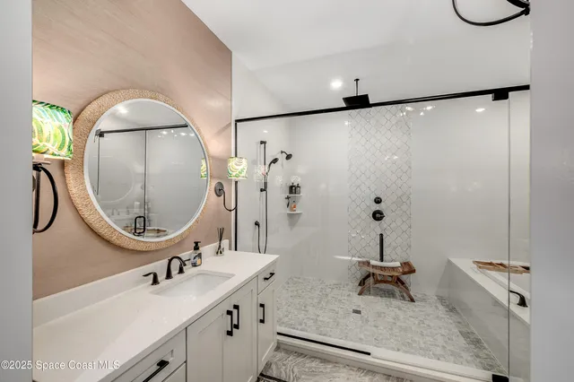a bathroom with a sink mirror and vanity