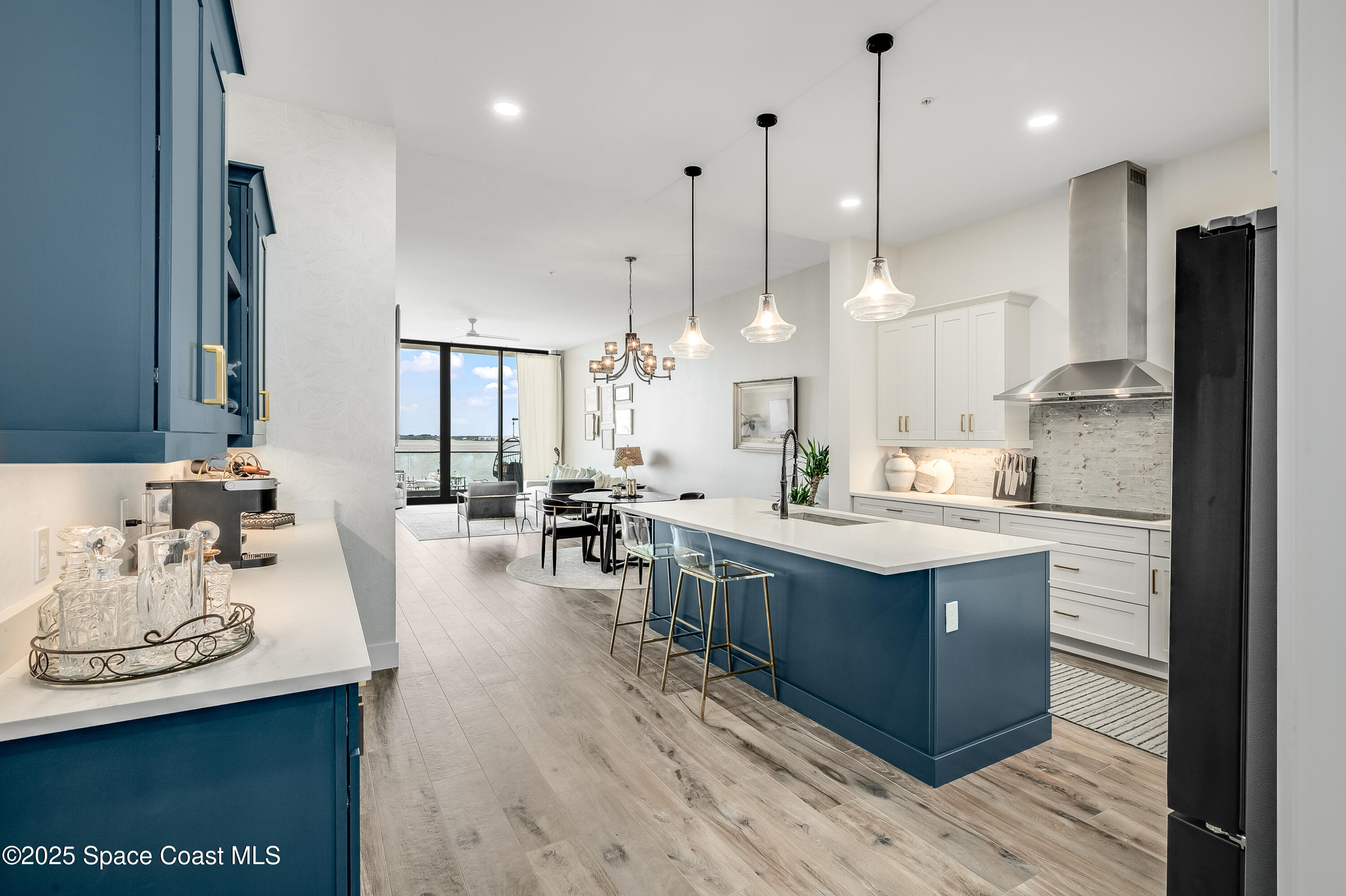 225 Strand Drive, Unit 404 Melbourne Beach, FL 32951 - Photo 3 of 51 a large kitchen with cabinets a sink a center island stainless steel appliances and a center island