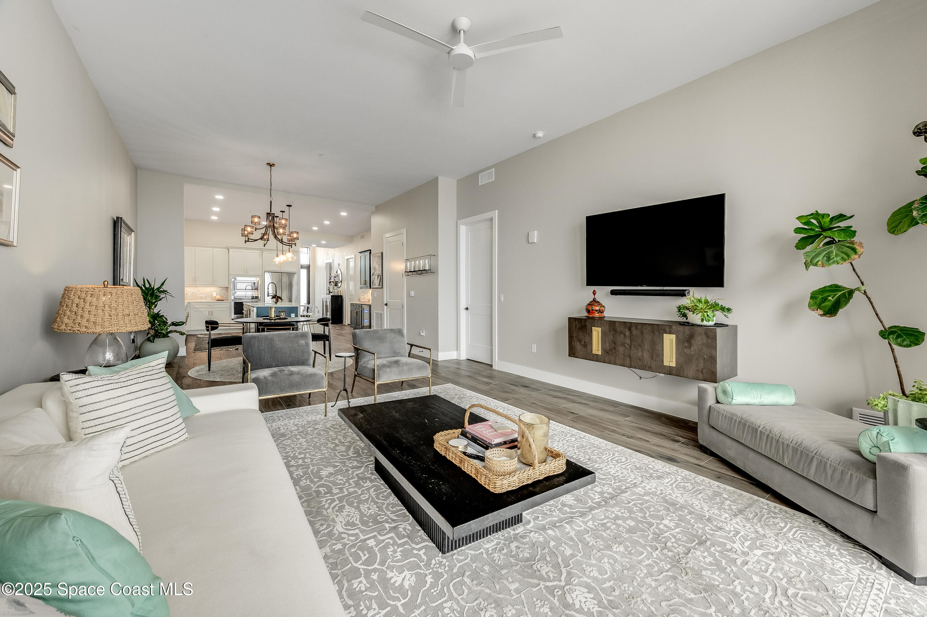 225 Strand Drive, Unit 404 Melbourne Beach, FL 32951 - Photo 36 of 51 a living room with furniture and a flat screen tv