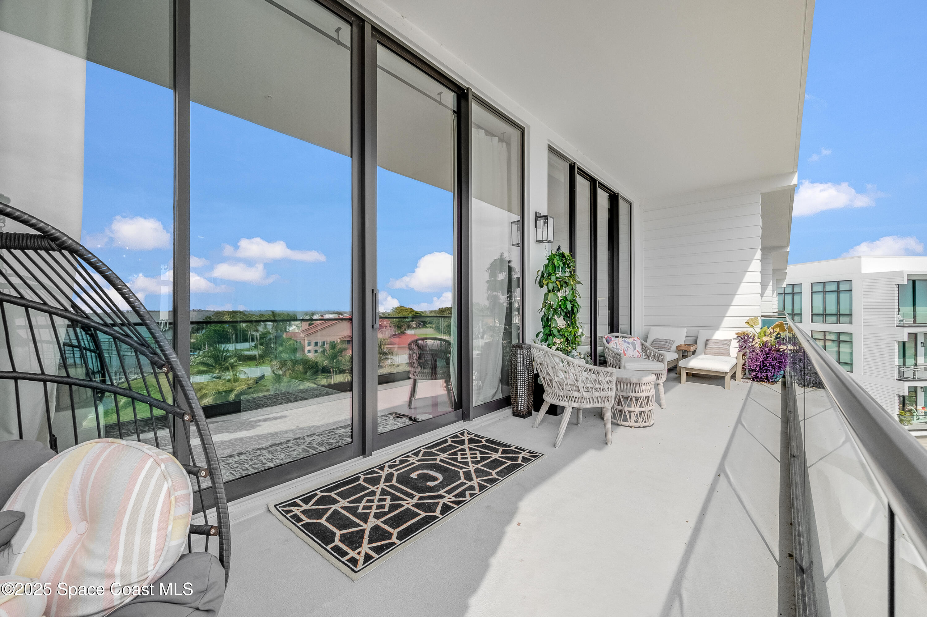 225 Strand Drive, Unit 404 Melbourne Beach, FL 32951 - Photo 38 of 51 a living room with furniture and a floor to ceiling window