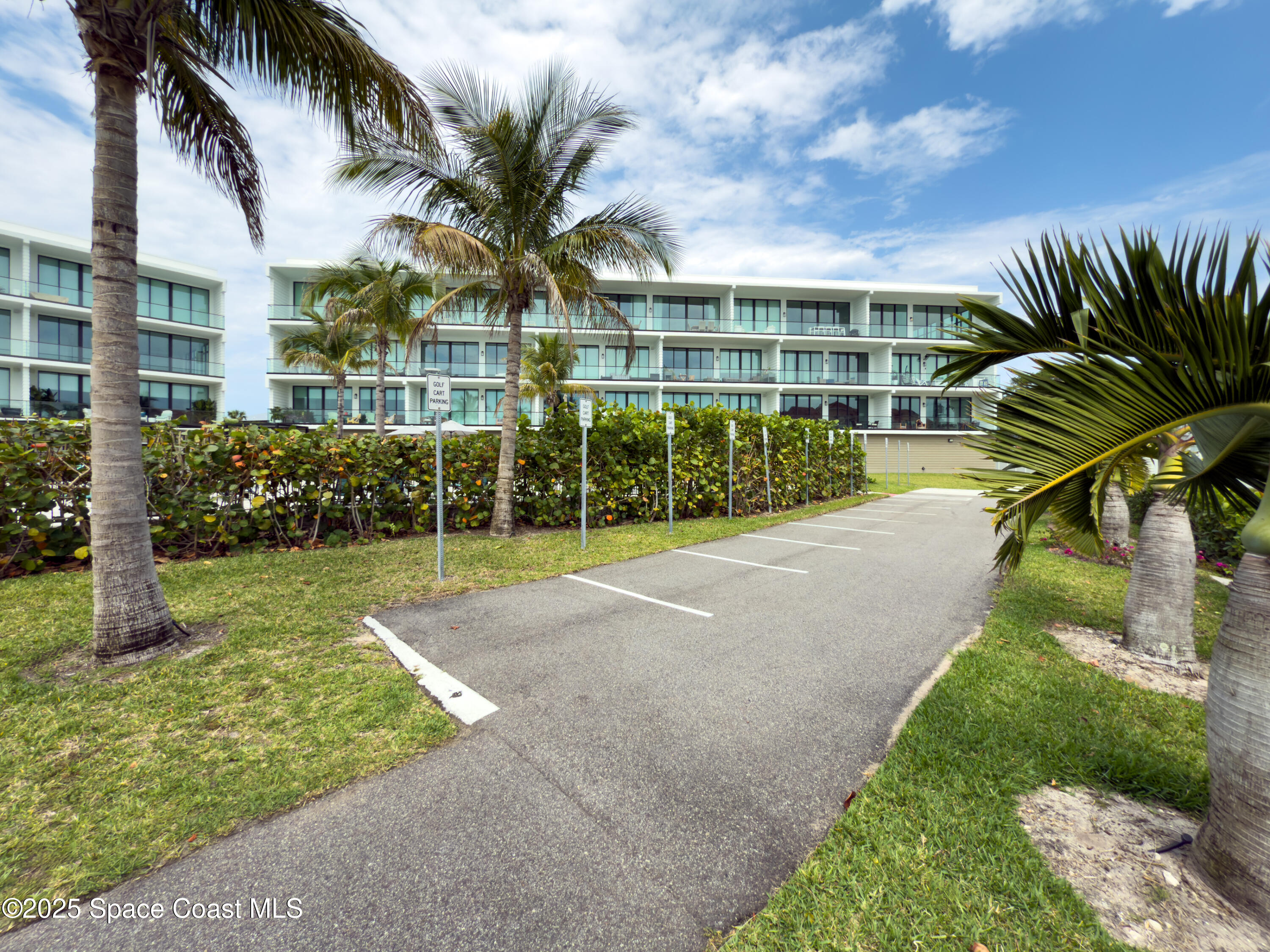 225 Strand Drive, Unit 404 Melbourne Beach, FL 32951 - Photo 45 of 51 a view of a house with a yard and potted plants