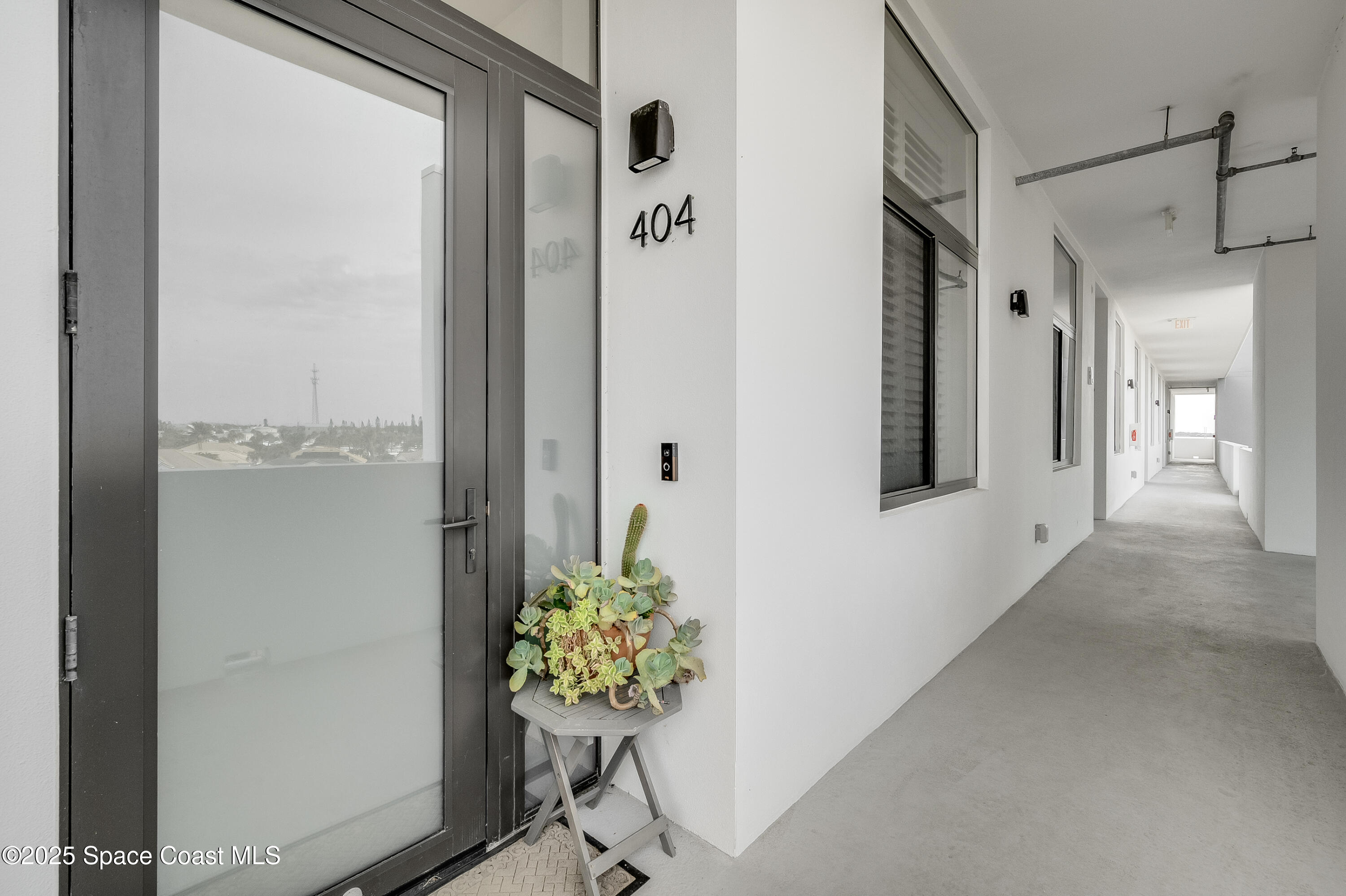225 Strand Drive, Unit 404 Melbourne Beach, FL 32951 - Photo 7 of 51 a hallway with painting and flowers