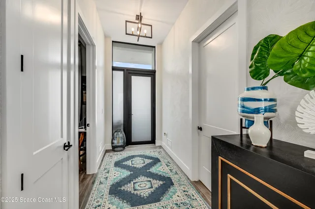 a view of bathroom with a potted plant on a sink and a mirror