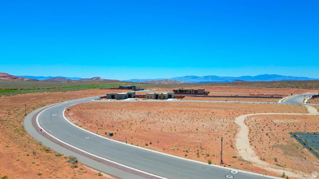 3306 South Endless Trail, Unit 33 Hurricane, UT 84737 - Photo 21 of 27 Expansive desert landscape featuring a paved road, undeveloped land, and distant residential structures