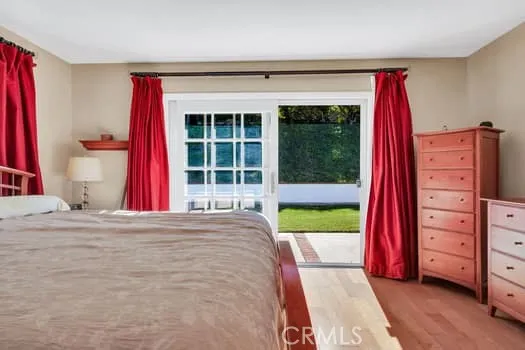 a view of a bedroom with a bed and a window