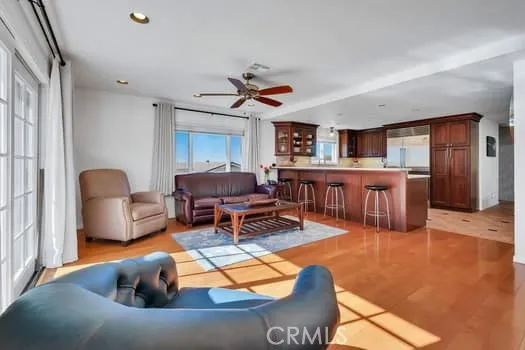 a living room with furniture a dining table and kitchen view