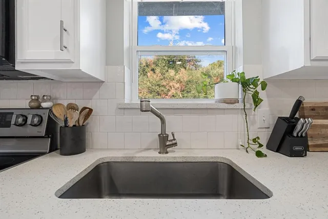 a close view of a sink a faucet and appliance in the kitchen