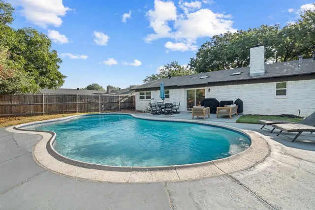 a view of a swimming pool with outdoor seating