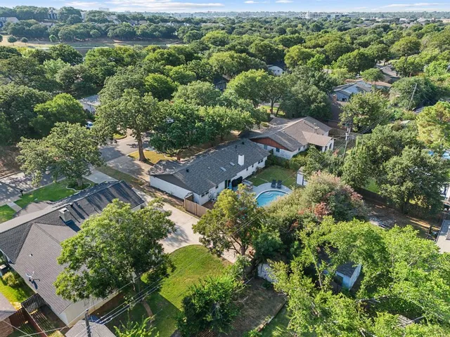 an aerial view of a house with yard