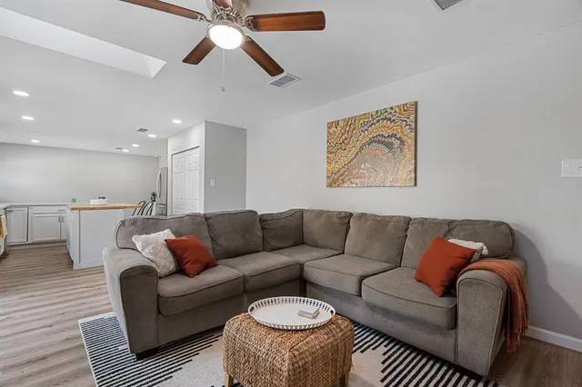 a living room with furniture and a chandelier