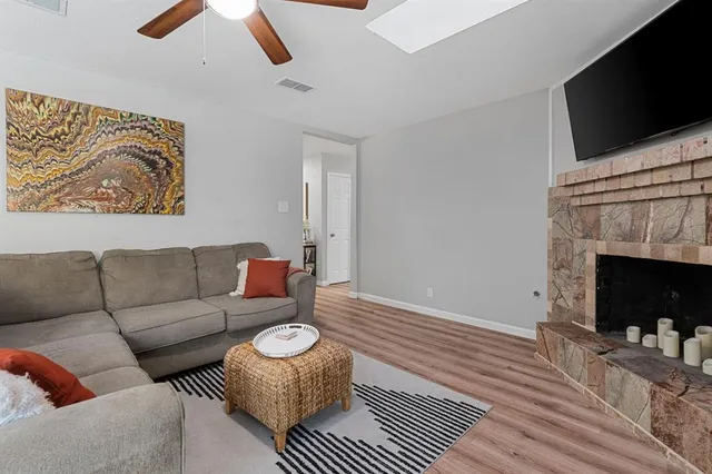 a living room with furniture a flat screen tv and a fireplace