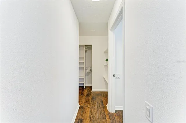 a view of a room with wooden floor lounge chair and windows