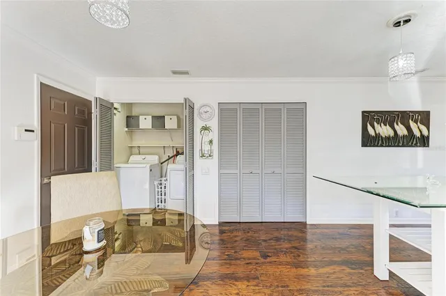 a dining hall with stainless steel appliances a dining table and chairs