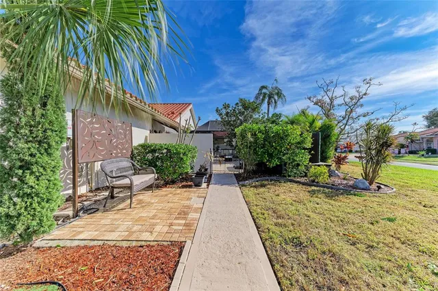 a living room with furniture a mirror and a chandelier