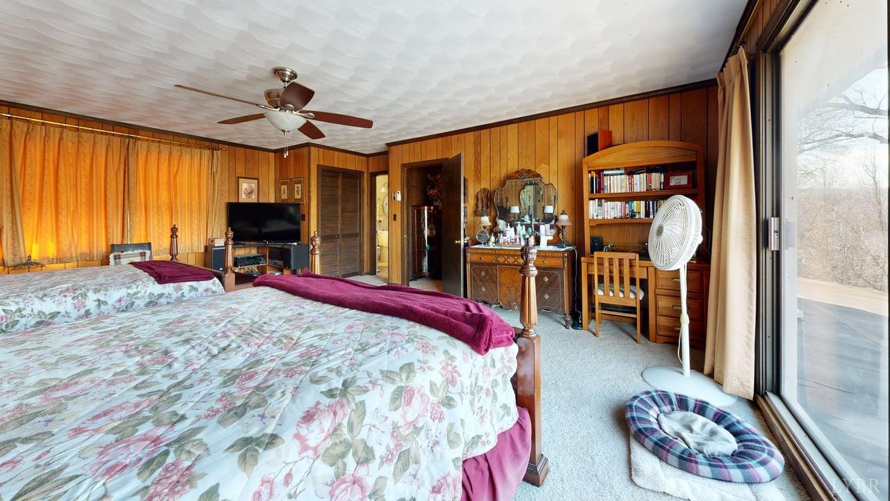 426 Burgess Road Madison Heights, VA 24572 - Photo 22 of 51 a bed room with a bed and a chandelier