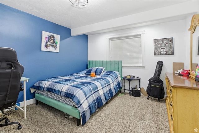 772 East 600 South Preston, ID 83263 - Photo 26 of 35 Carpeted bedroom featuring a window with blinds, a ceiling-mounted light fixture, and a built-in architectural beam