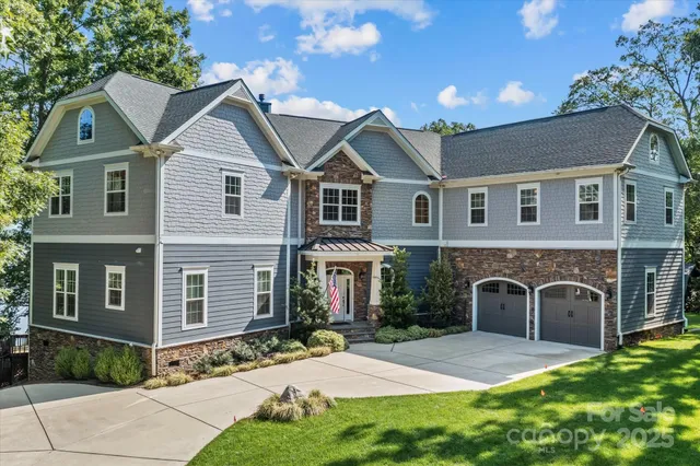 a front view of a house with yard and parking