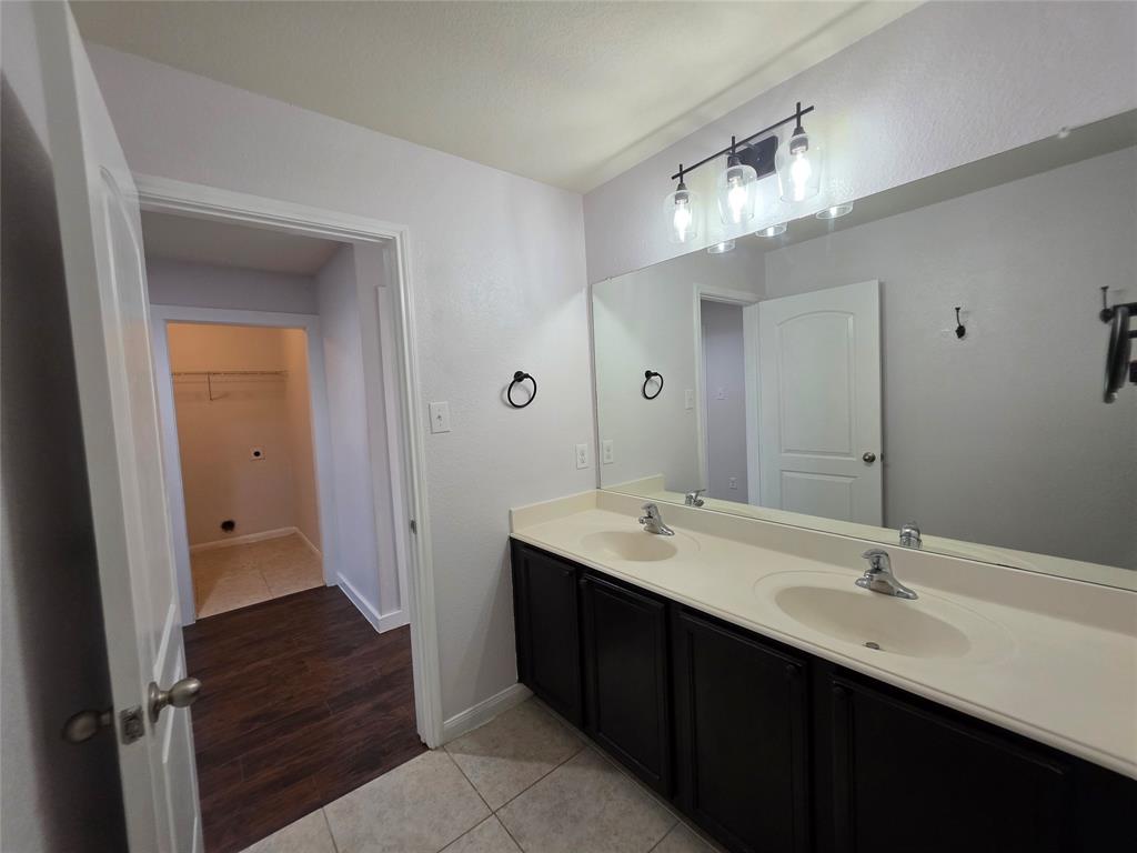149 Ryan Street Anna, TX 75409 - Photo 26 of 38 a bathroom with a double vanity sink and a mirror