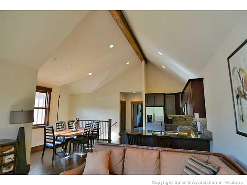 853 Independence Road, Unit 5B Keystone, CO 80435 - Photo 5 of 25 a kitchen with stainless steel appliances refrigerator dining table and chairs